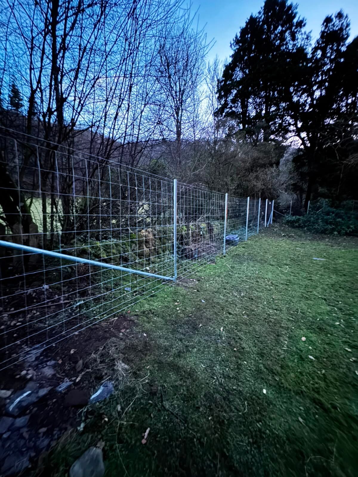 Fencing work on a smallholding with tractors and livestock