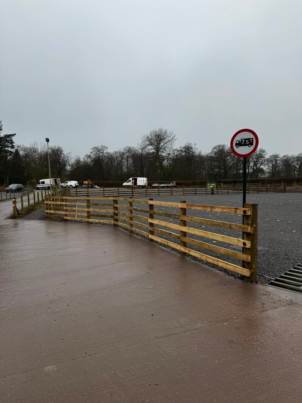 Post-and-rail fencing around a newly built equestrian arena