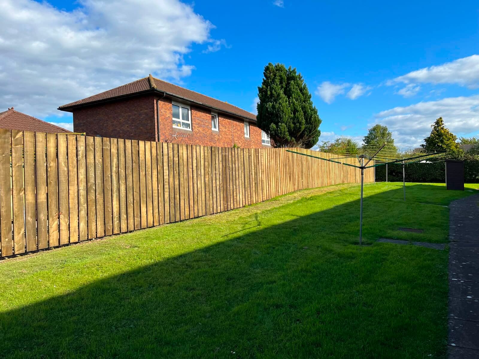Close-board timber fence along a back garden boundary