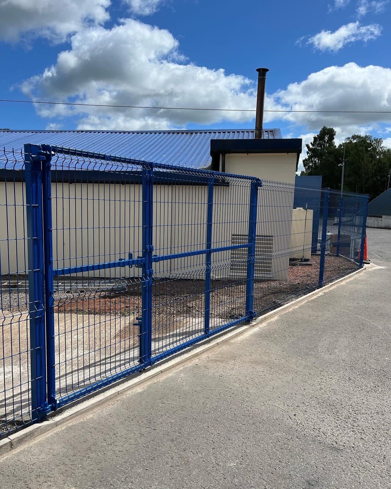 Weldmesh perimeter fencing and gate securing a commercial site
